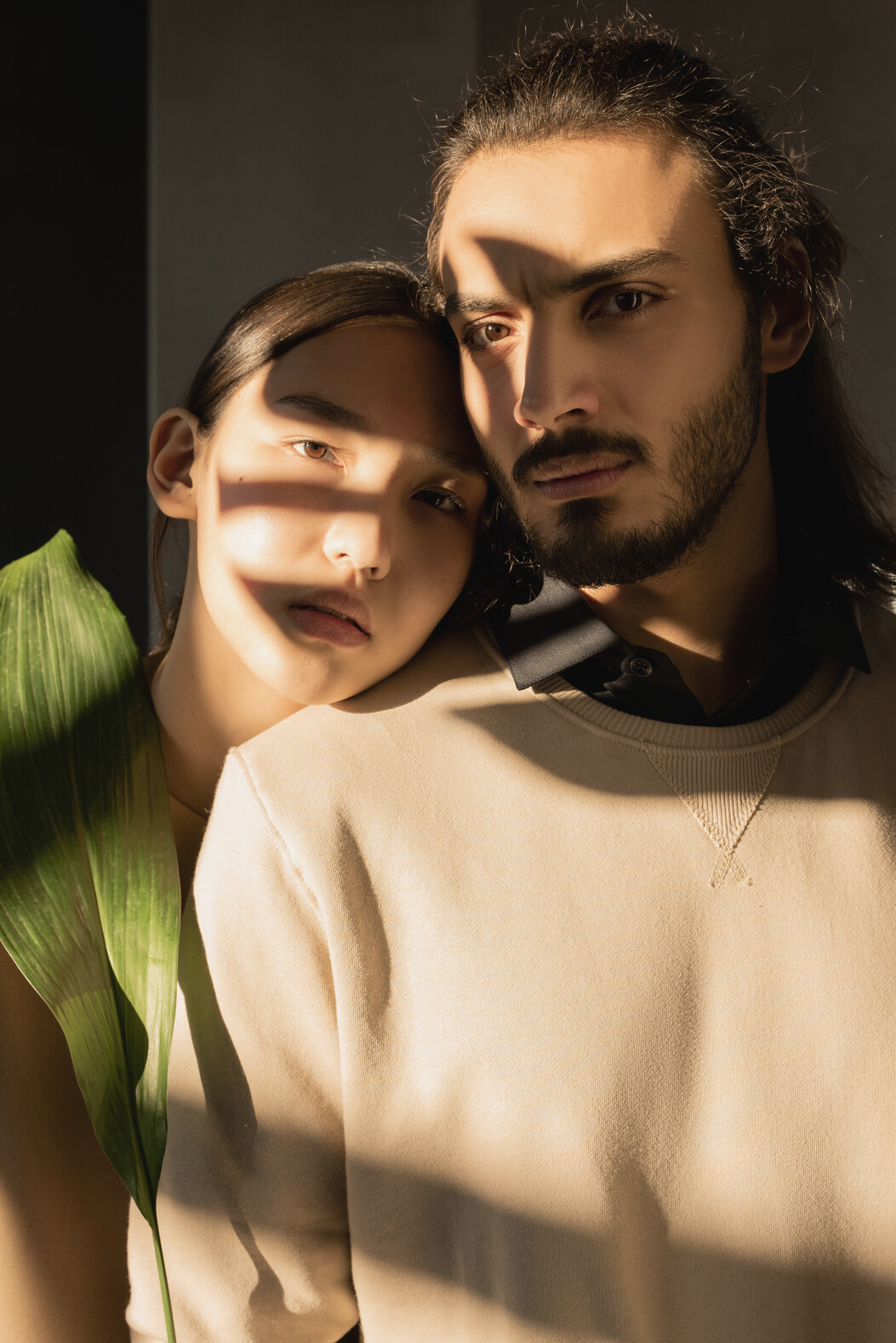 Man in Brown Crew Neck Shirt Beside Woman Holding Green Leaf